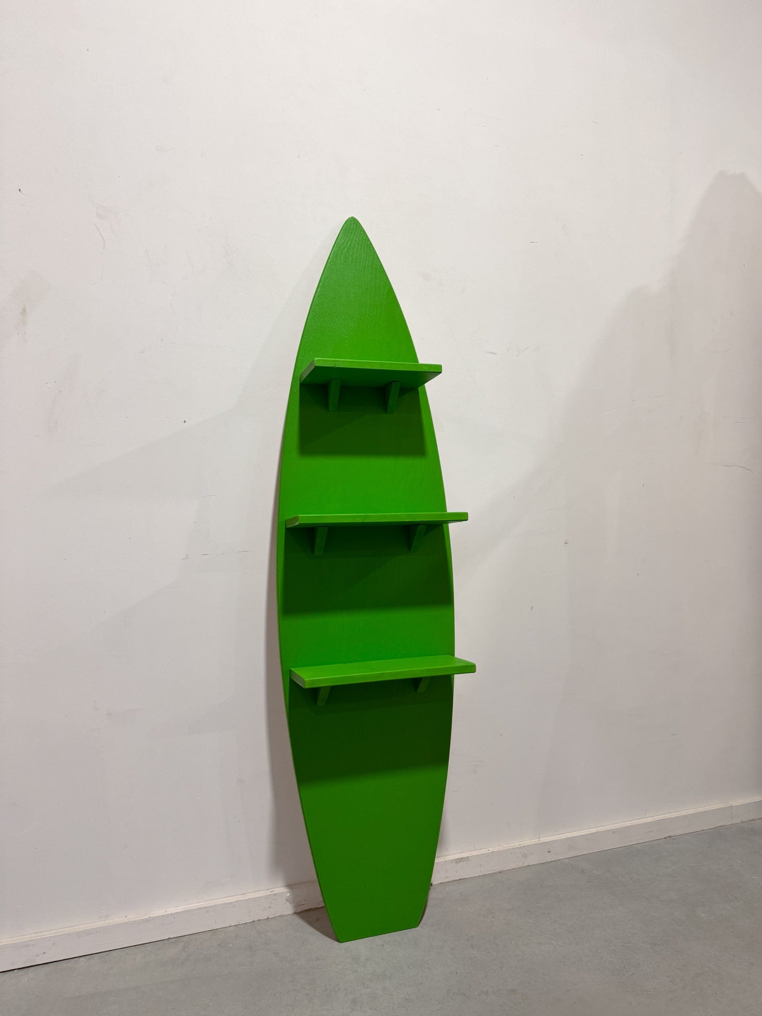 Handcrafted green surfboard shelf with three sturdy levels, ideal for showcasing decor items