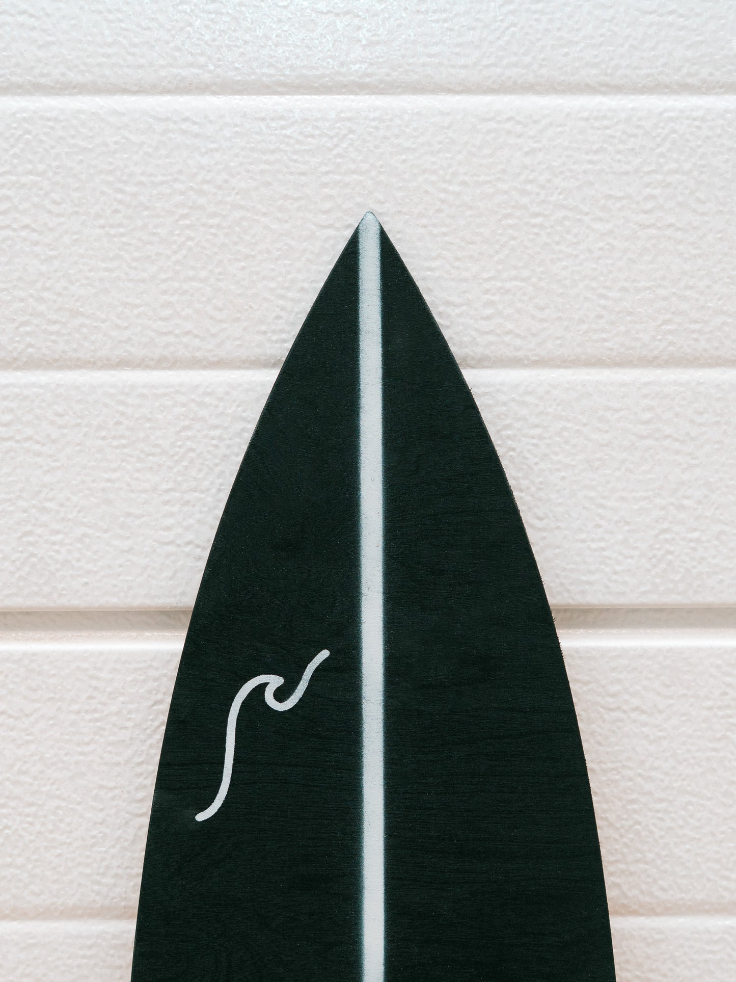 Black and white pattern minimalistic surfboard with wave graphic.