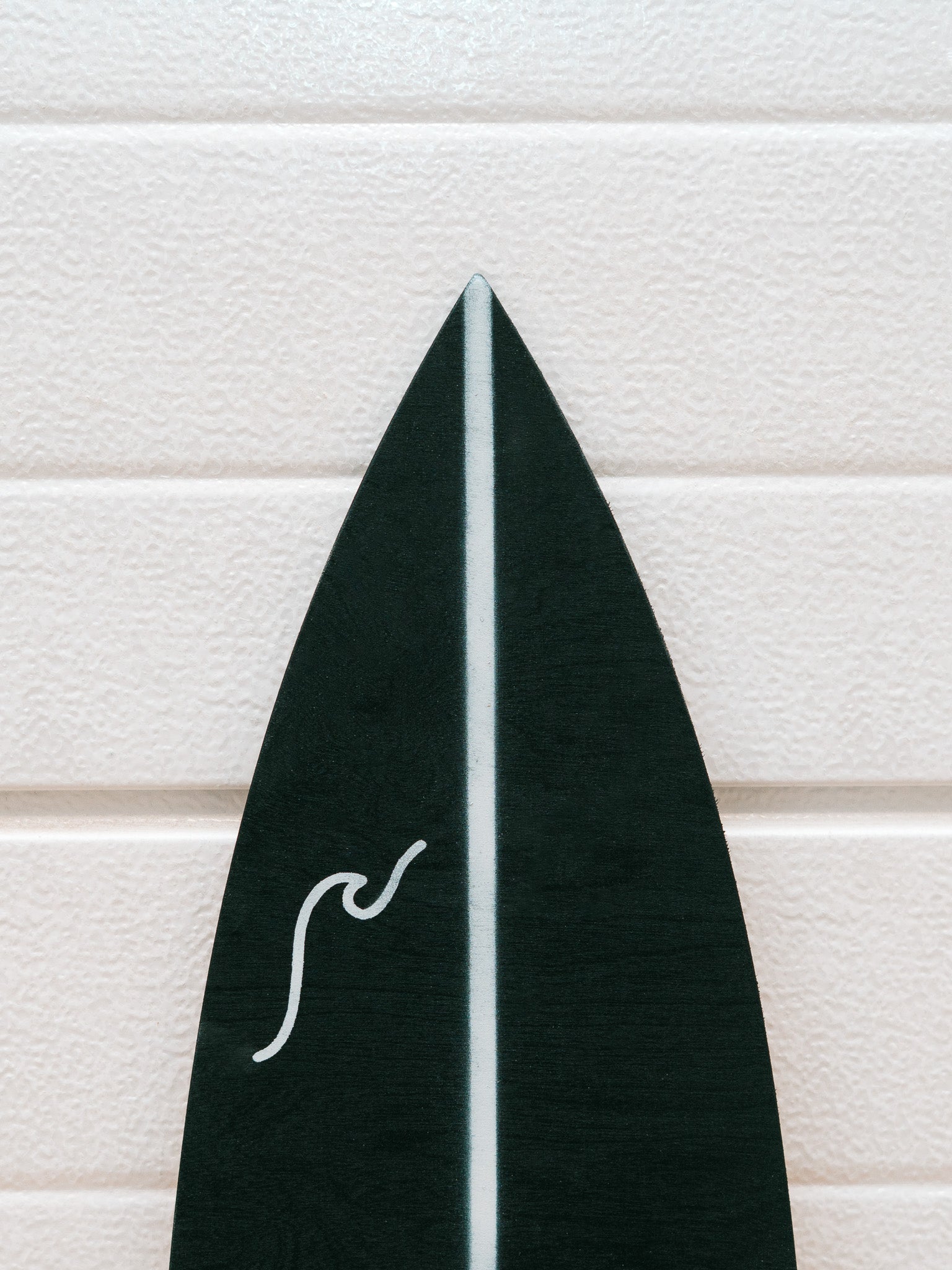 Black and white pattern minimalistic surfboard with wave graphic.