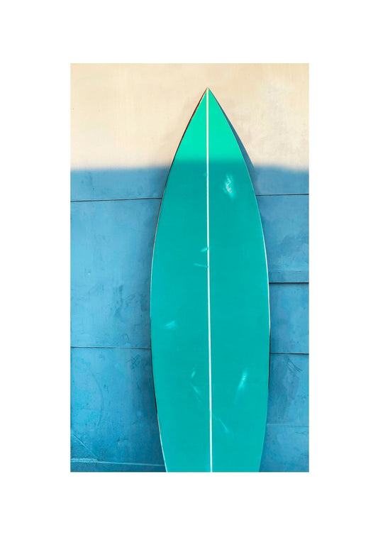 Turquoise green wooden decorative surfboard, a vibrant coastal accent for stylish interiors.