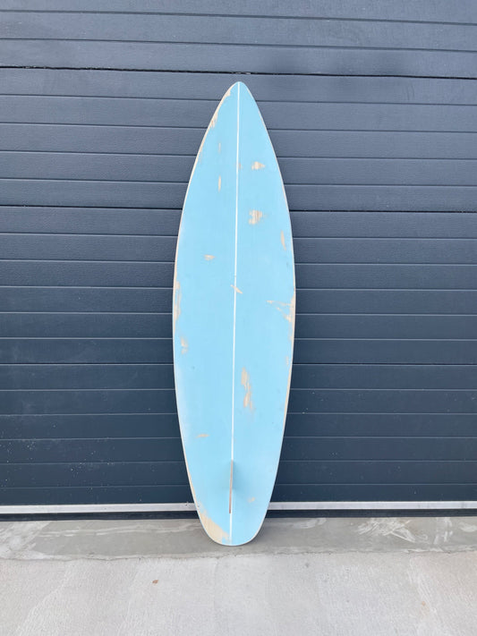 Time-worn charm: Vintage-inspired baby blue surfboard with elegance